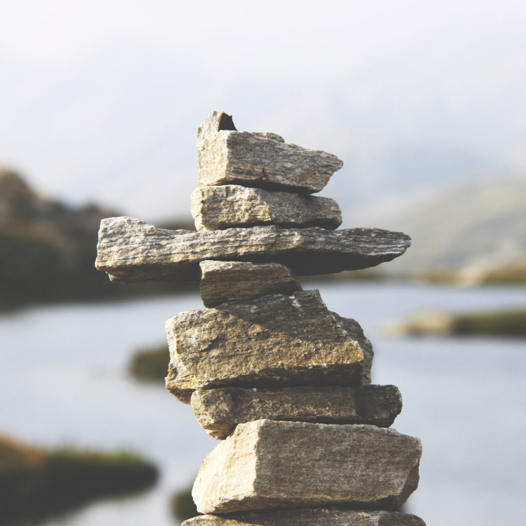 photo of rocks stacked in nature near a body of water