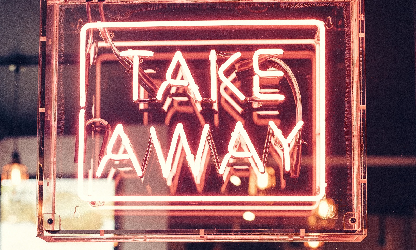 Take away neon sign—article about Opportunity Zones