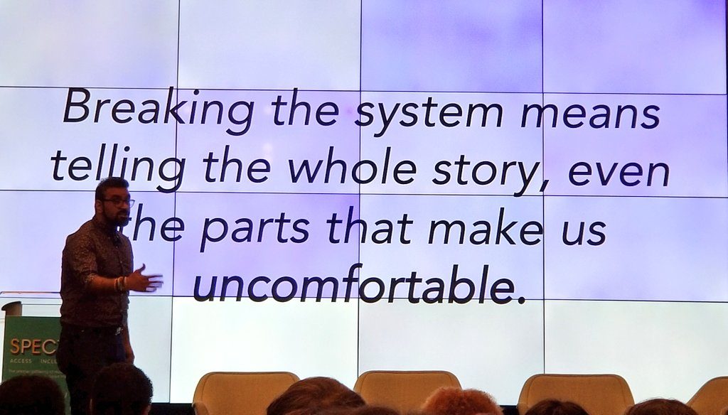 Rohit Malhotra, Center for Civic Innovation Atlanta in front of quote that says "Breaking the system means telling the whole story, even the parts that make us uncomfortable."