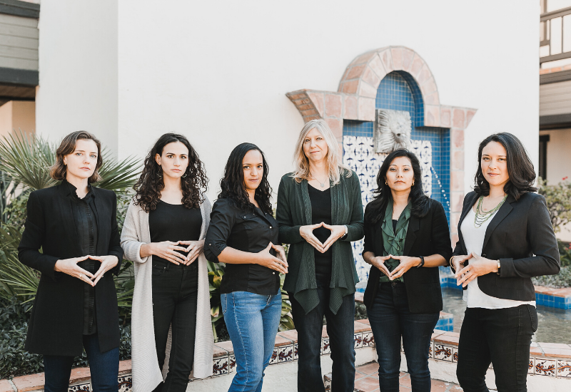 The women of Mission Driven Finance demonstrating Angela Merkel's Merkel-Raute, or diamond of power