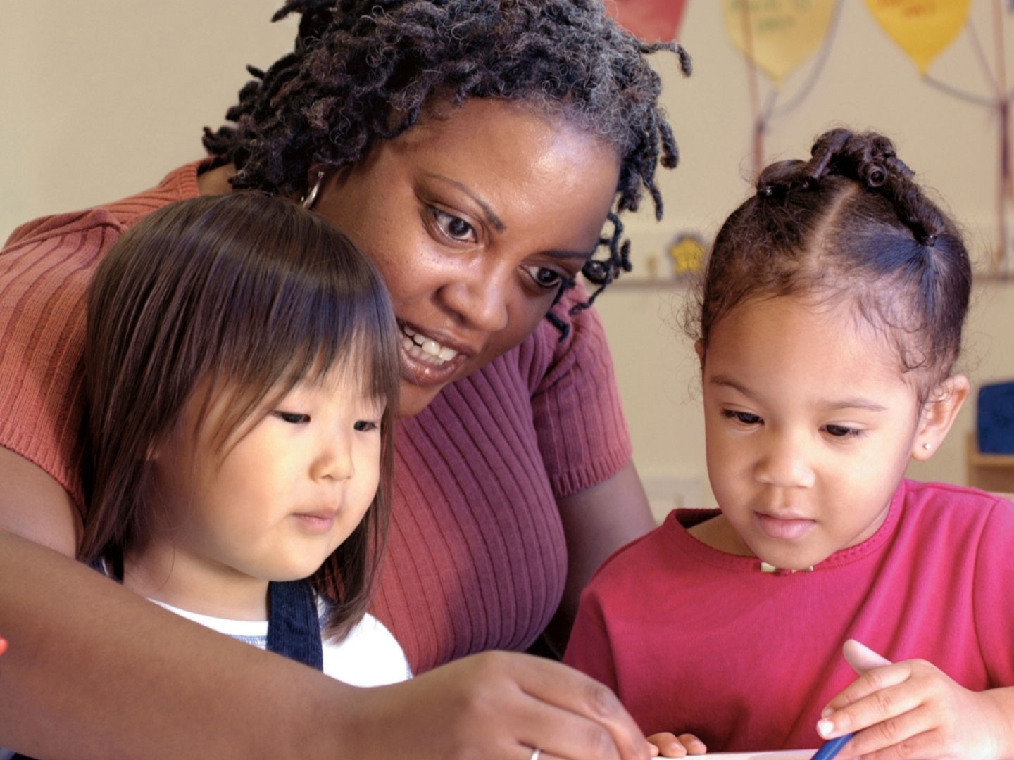 childcare-1440 a child care worker with two young kids