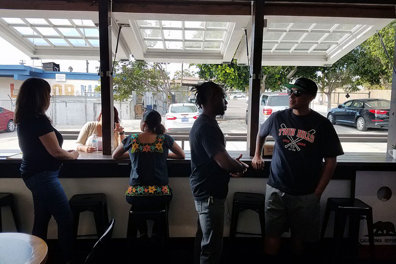 Tommy Walker and other owners of Project Reo Collective gather at their coffee shop, Sept. 30, 2018