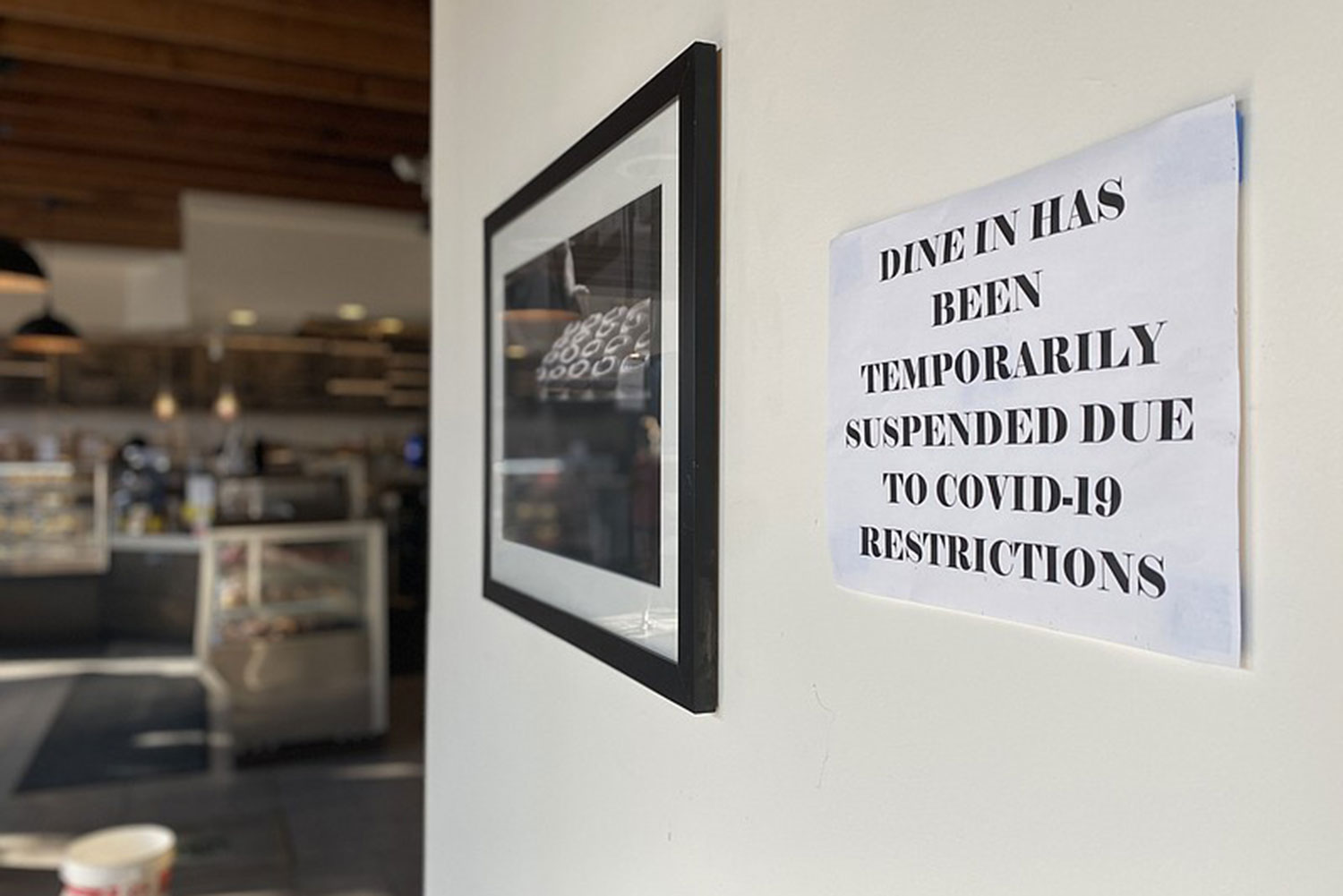 A sign notifying customers dine-in has been temporarily suspended because of the coronavirus pandemic at Solomon Bagels & Donuts in North Park. Oct. 1, 2020