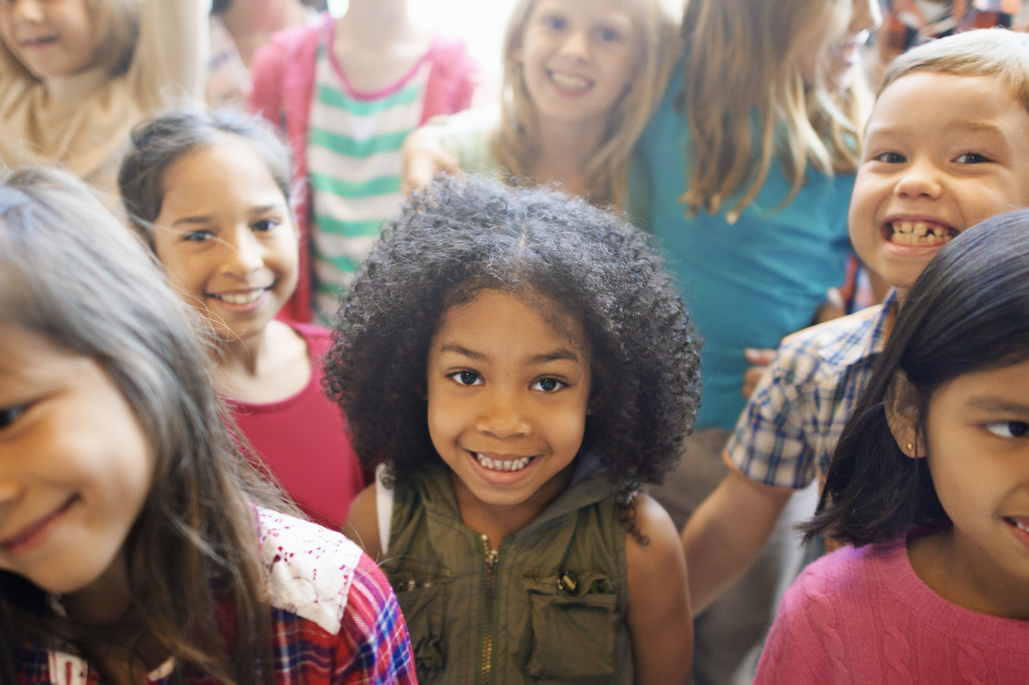 group of school-age kids smiling at camera