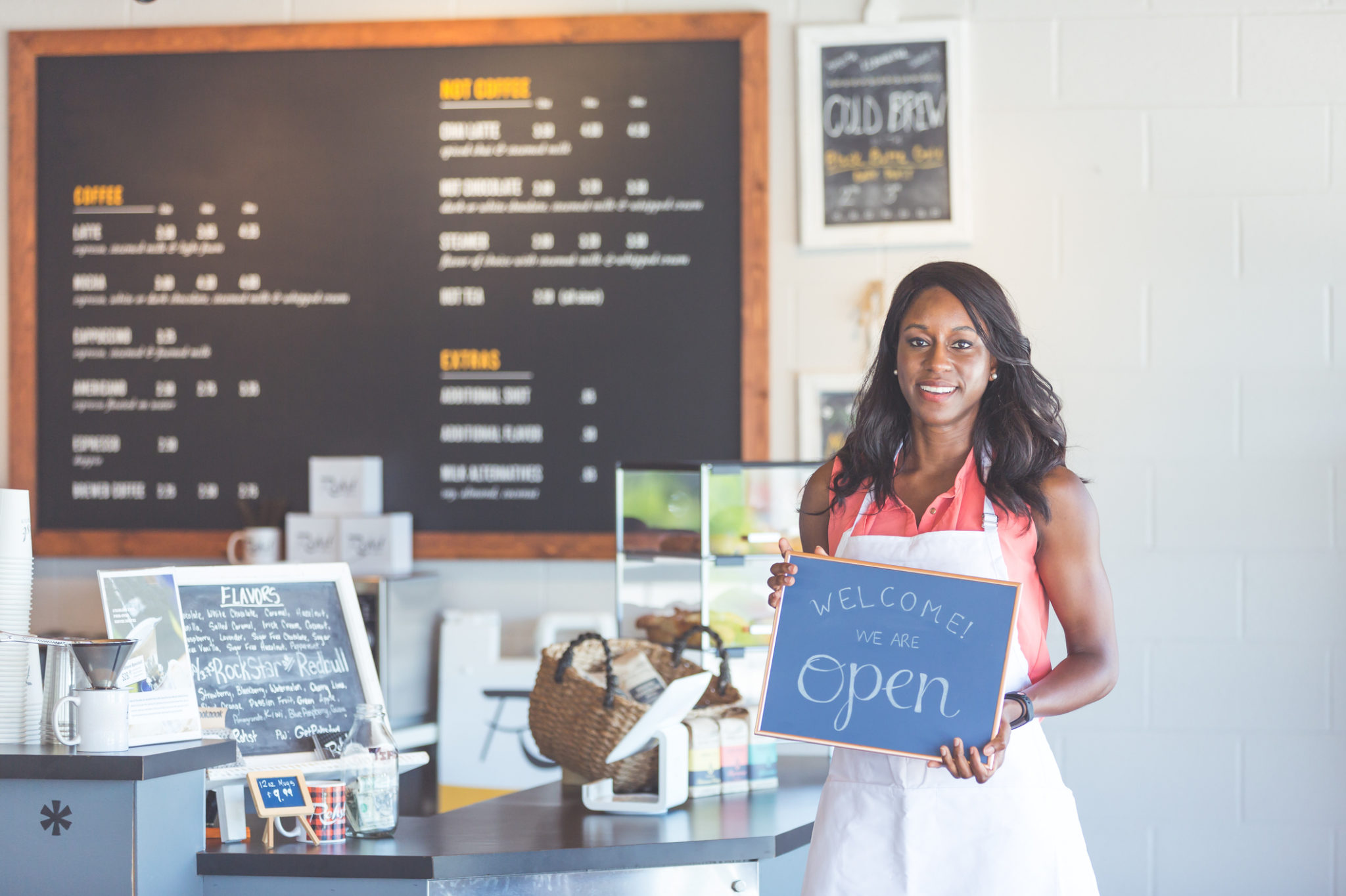 Proud coffee shop owner hold open sign on first day of business