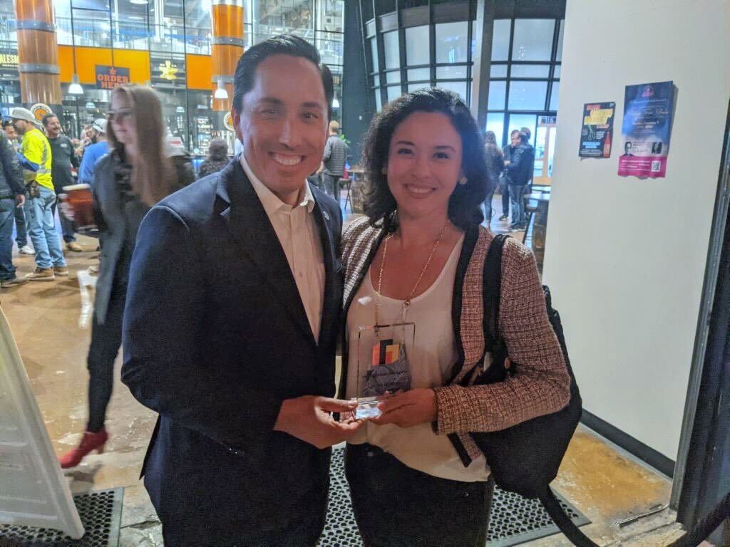 City of San Diego Mayor Todd Gloria presents the Immigration Advocate award to Lauren Grattan