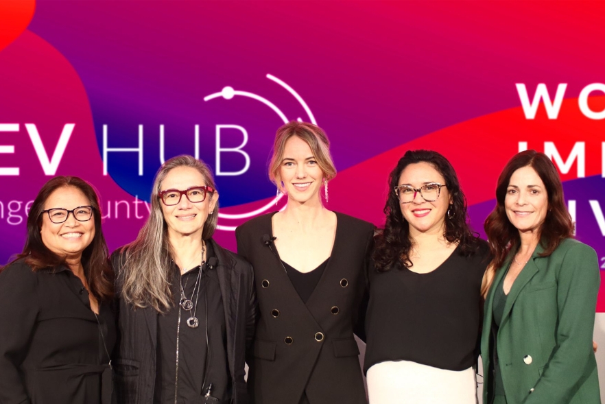 5 women smile into the camera